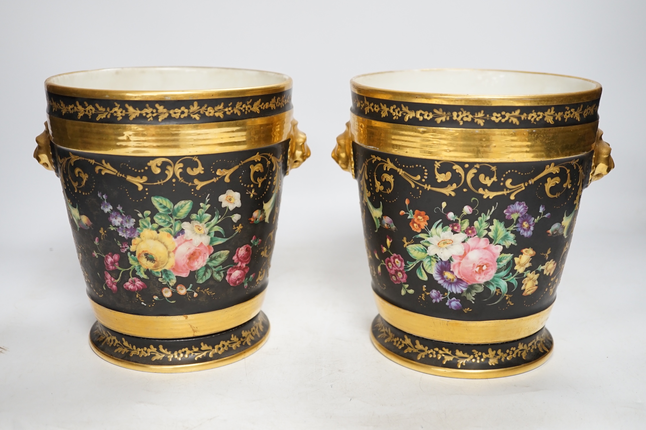 A pair of Paris porcelain cache pots and under dishes, black ground, floral and gilt decoration, 18.5cm high. Condition - both have wear to gilding and black ground, one pot has a star crack to base